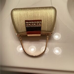 Small gold tone evening purse.  No tag but never used. Don’t know original cost
